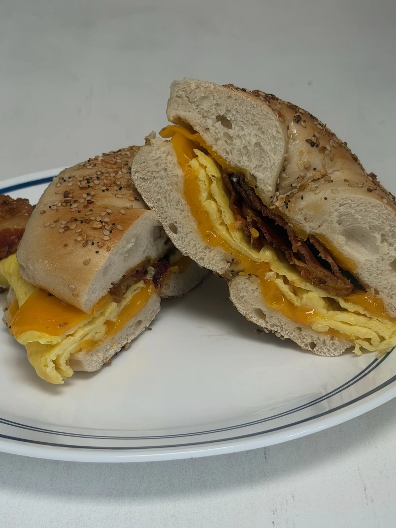 Bacon, Egg & Cheese on an everything bagel — sliced open to show every layer
