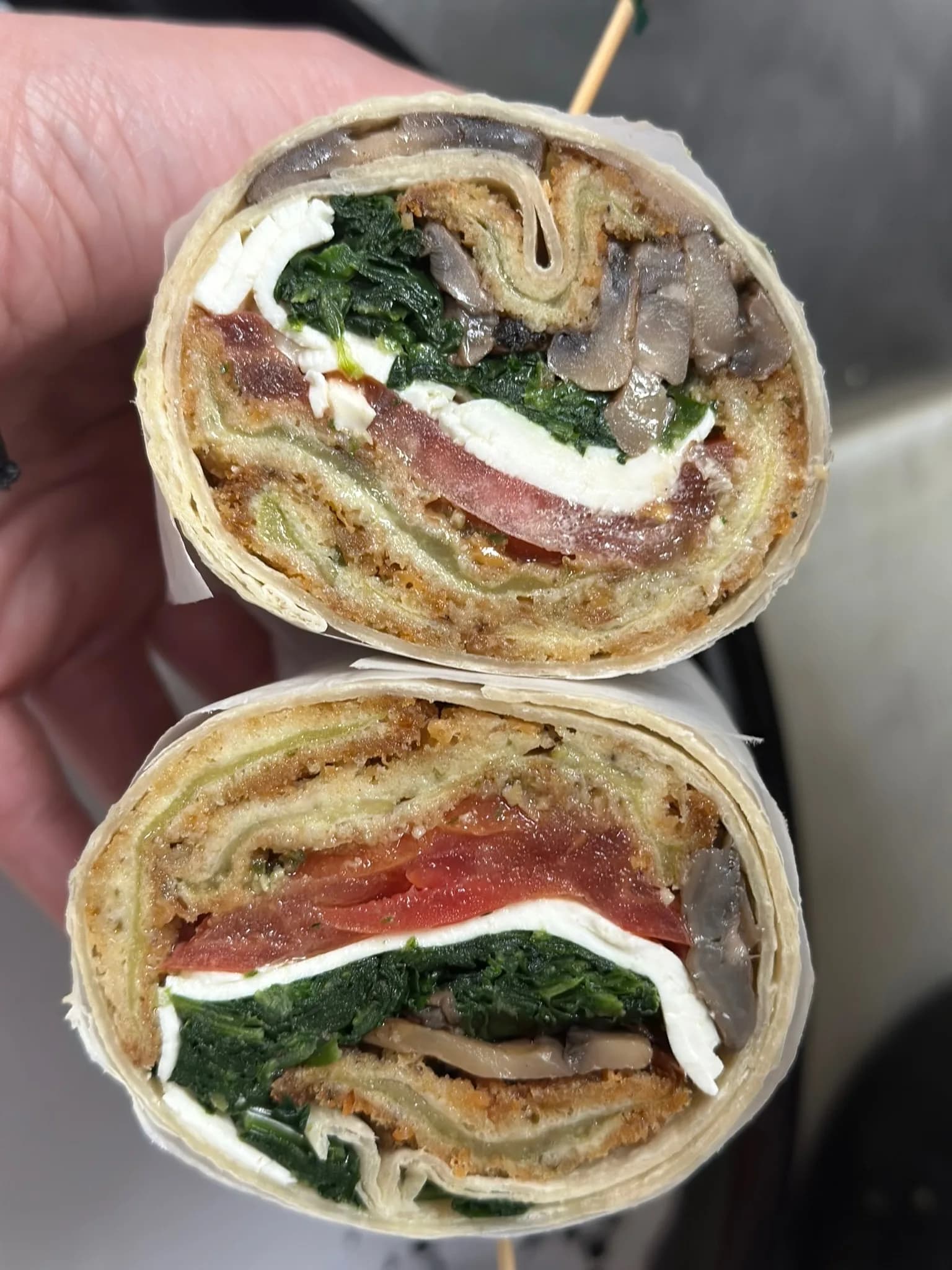 Chicken cutlet wrap pressed on the grill — breaded cutlet, melted cheese, and fresh greens