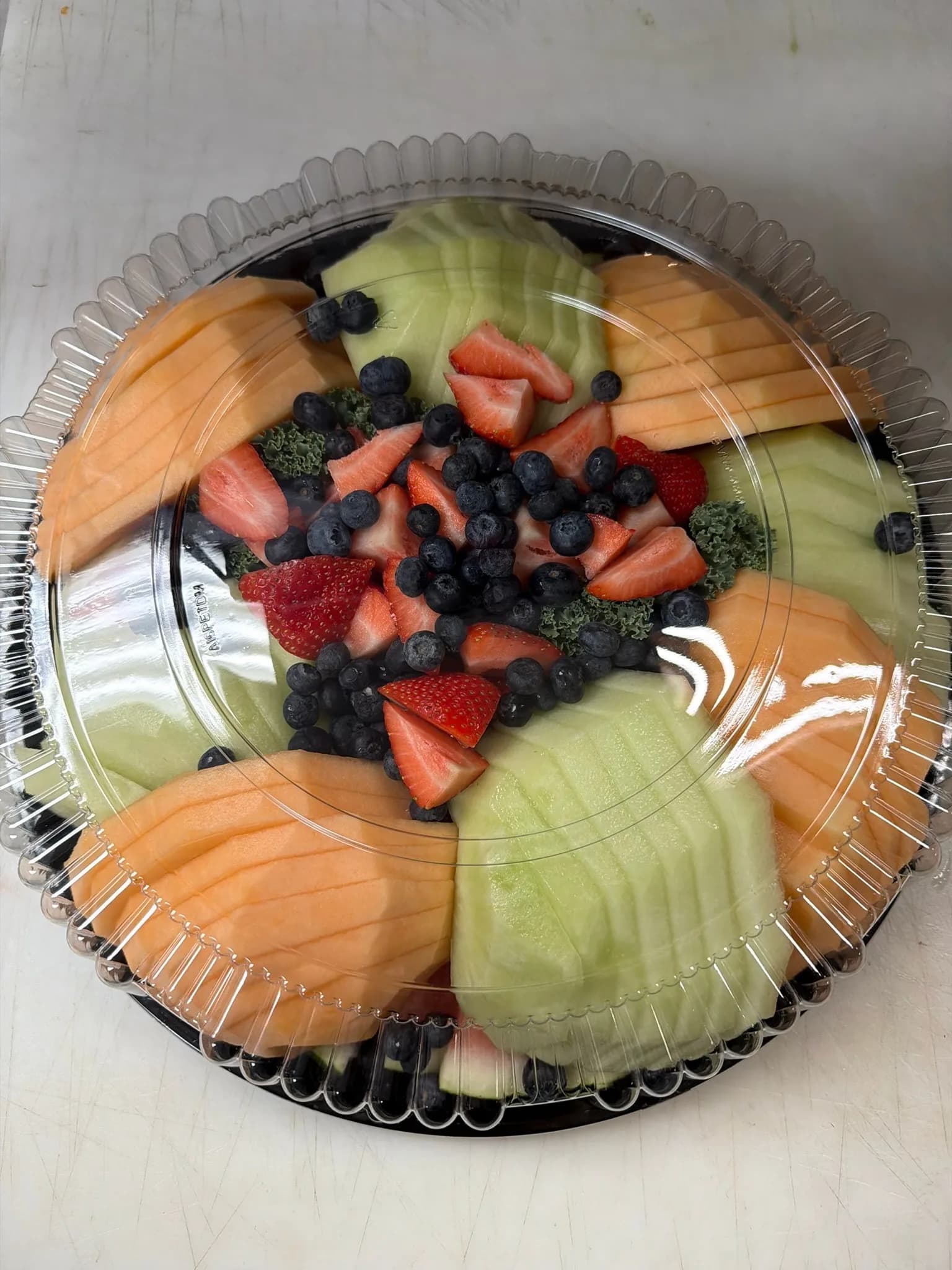 Our Fruit Platter — a beautiful arrangement of melon, pineapple, strawberries, and grapes for the party
