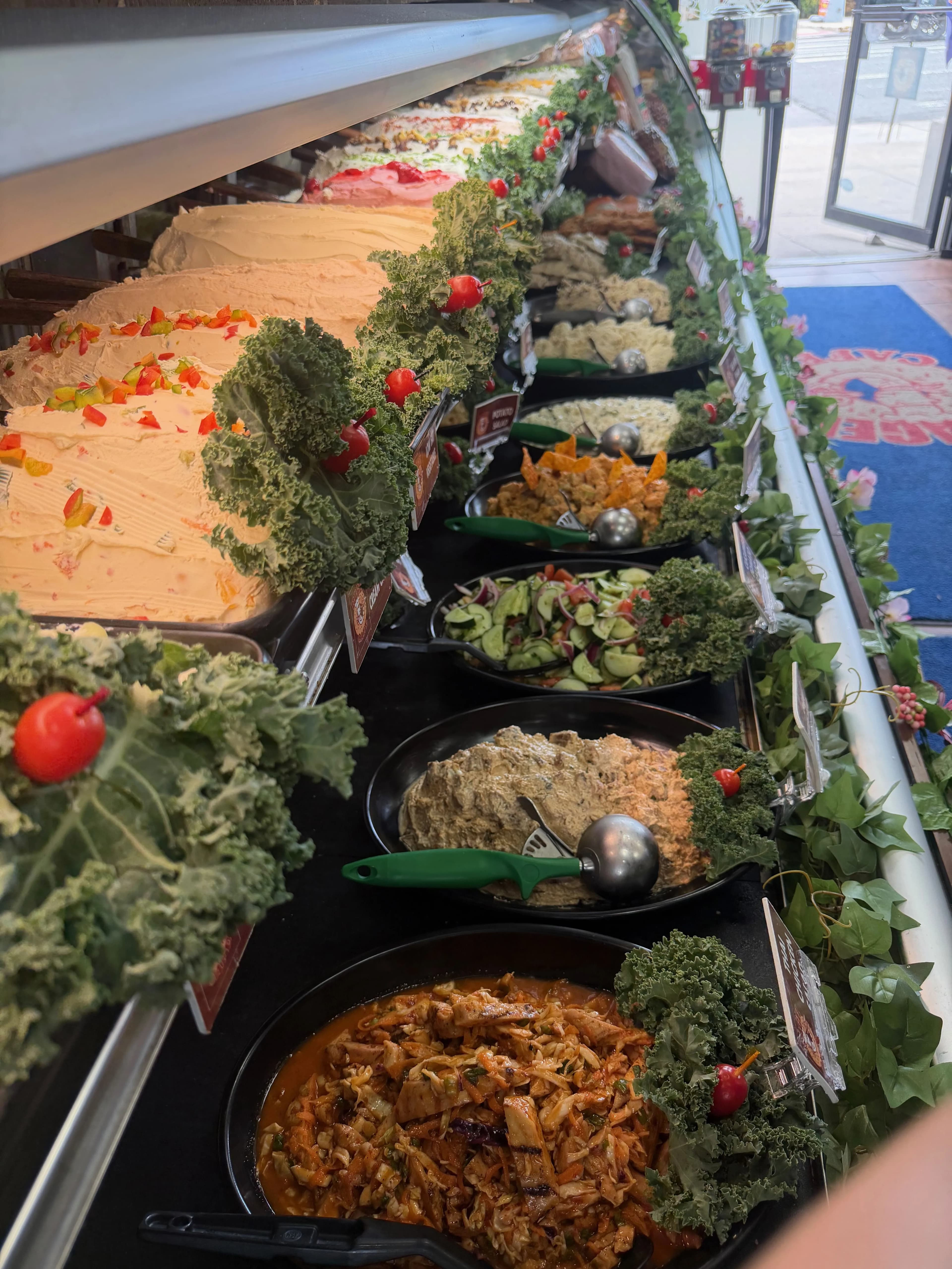 The Chop It Up bar — fresh greens, chopped veggies, beans, eggs, and homemade salads, ready to go