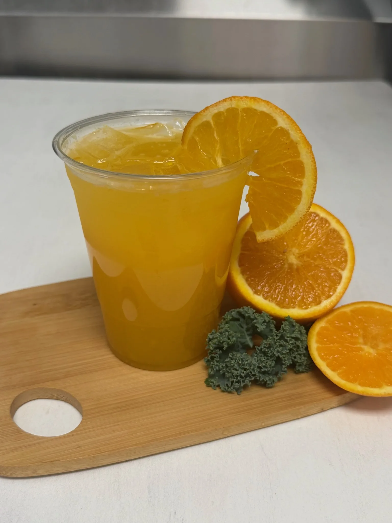 Fresh-squeezed Orange Juice, golden and pulpy, in a cup ready to grab