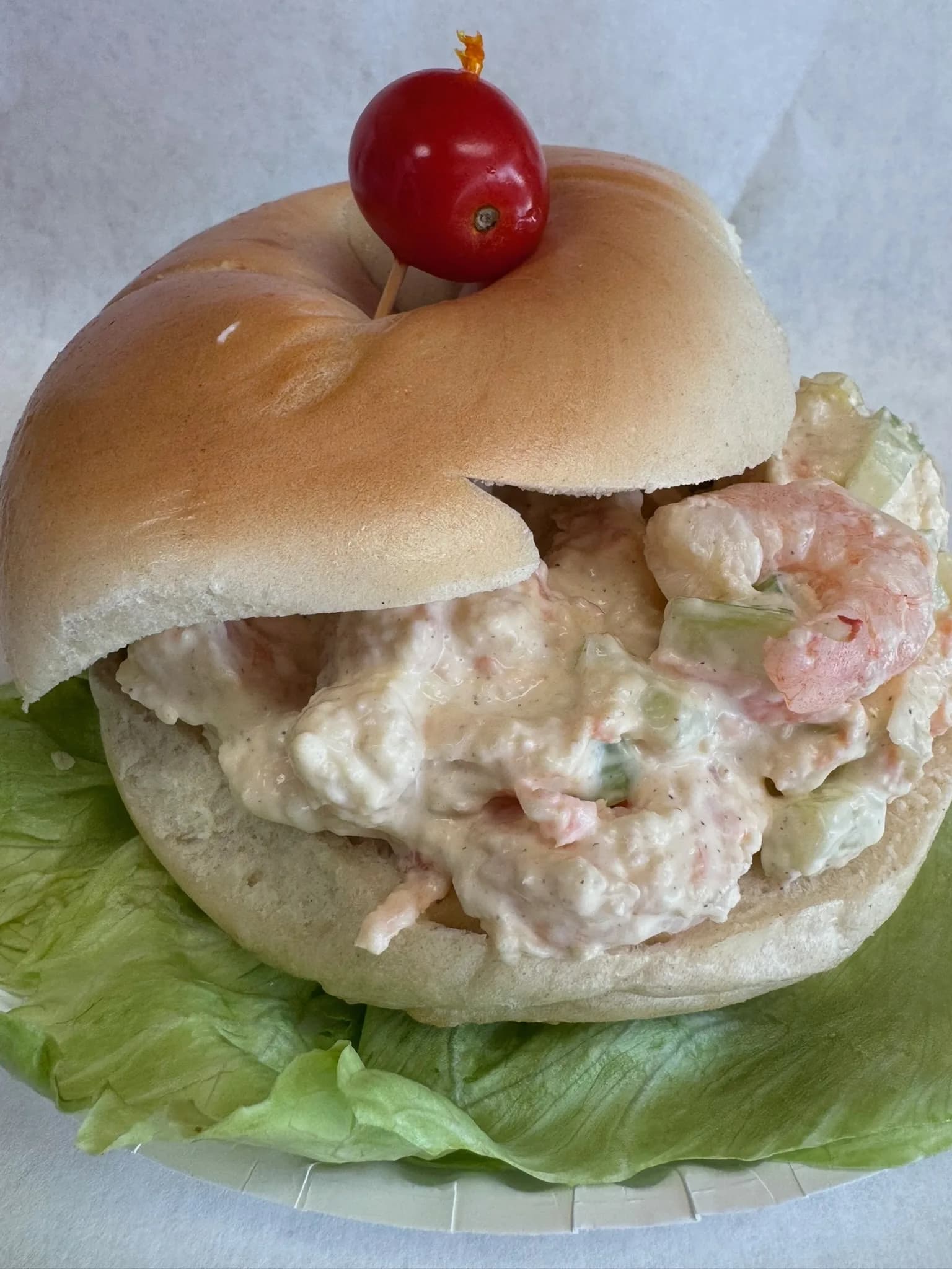 Our seafood salad — chunks of lobster and shrimp in light mayo, piled on a plain bagel
