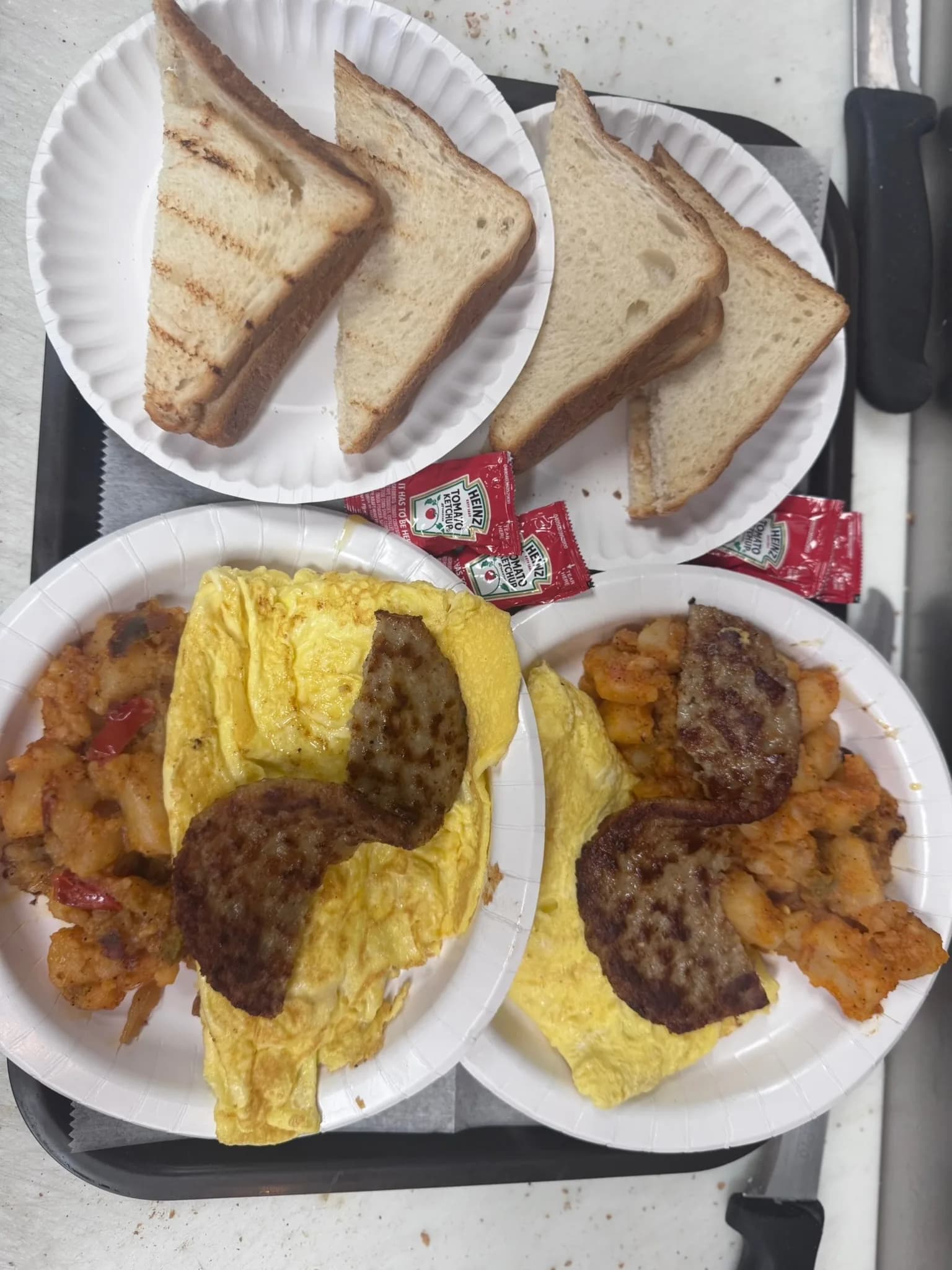 Three-egg omelette with sausage, served with home fries and grilled toast