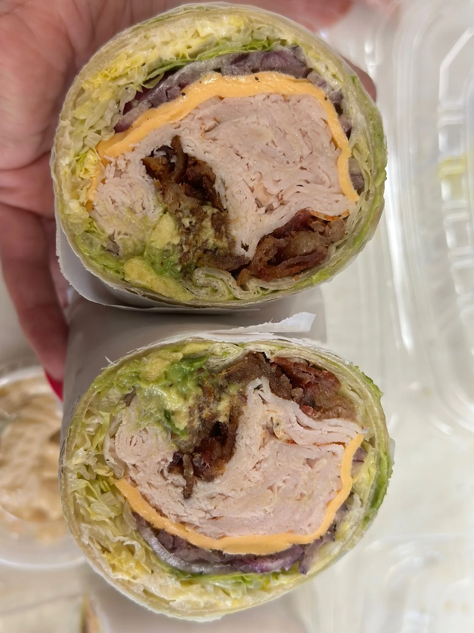 Turkey lettuce wrap loaded with American cheese, crispy bacon, and onions