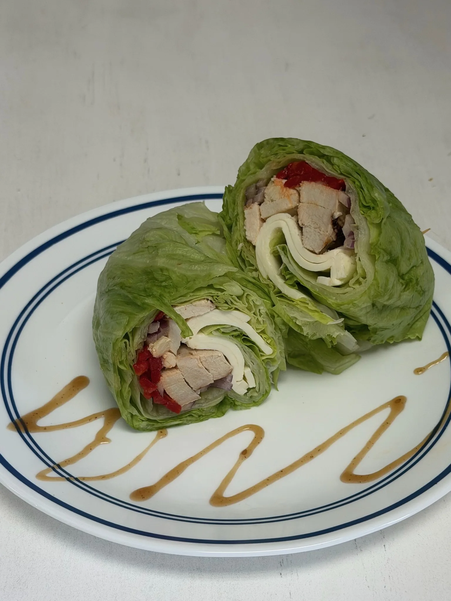 Turkey Lettuce Wrap — sliced turkey breast, Swiss cheese, and ripe tomato